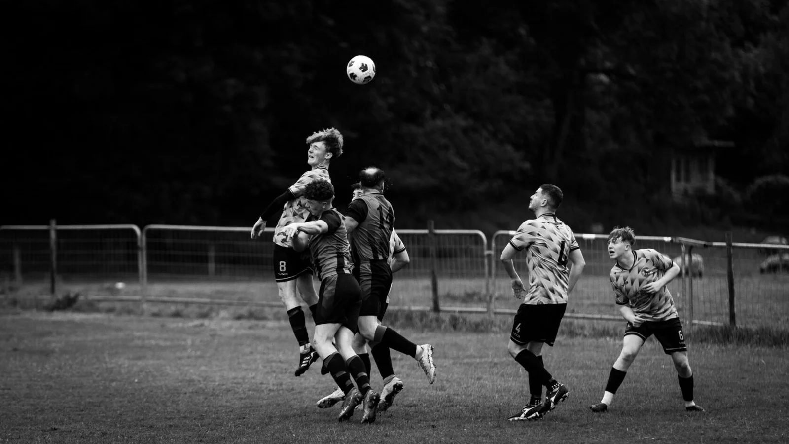 Four players rising together to contest a header