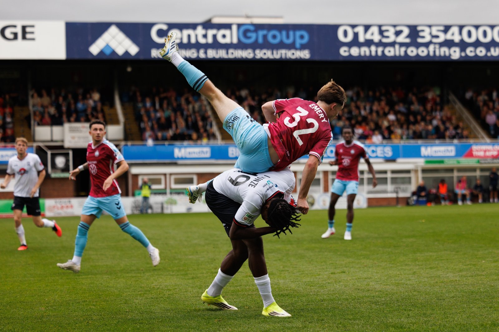 Two players colliding in an acrobatic aerial challenge