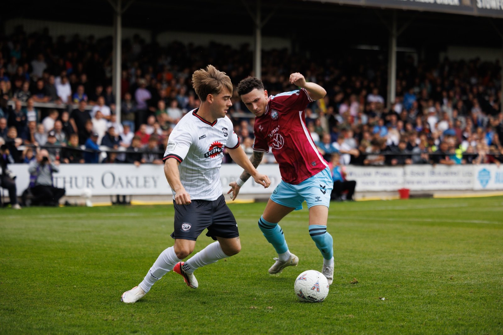 Hereford FC player taking on an opponent in midfield